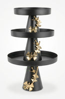 Black butterfly cake tray presented on a celebration dessert table with contemporary decorations.