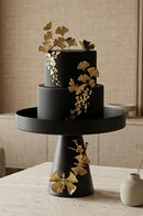 Black butterfly style cake tray displayed on a marble dining table in a modern home.