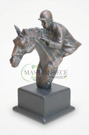 Brown jockey statue styled on an executive office desk with books and refined accessories.