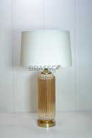 Buy Brassco Champagne Lining Glass Table Lamp featuring premium champagne glass, elegant lining design, fabric shade, E27 bulb compatibility, and warm ambient lighting for luxury home interiors.