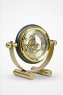 Decorative black and gold clock arranged on an executive office desk with elegant accessories.