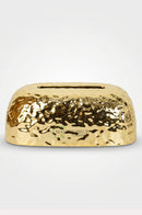 Decorative gold tissue holder with dotted detailing for a modern dining table