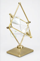 Geometric glass sand timer with gold metal detailing styled on an executive office desk.