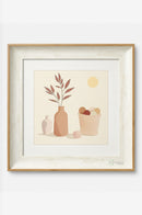 Kitchen-themed framed artwork mounted near a countertop with cooking accessories.