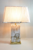 Luxury marble effect touch table lamp with gold geometric accents and cream fabric shade, featuring touch control and warm ambient lighting for modern interiors.