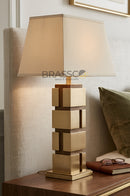 Modern wooden box lamp placed on a table, creating a cozy and elegant atmosphere.