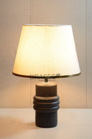 Elegant black ceramic table lamp with fabric shade, providing warm ambient lighting for bedrooms, living rooms, and modern home interiors.