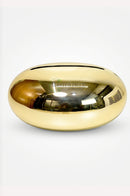 Oval-shaped gold tissue holder for modern dining tables and living room consoles