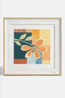 Square yellow floral artwork decorating the wall beside a cosy reading chair.
