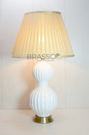 The clean white ceramic finish creates a fresh, modern appearance, while the polished brass accents introduce a luxurious touch that complements both classic and contemporary décor.