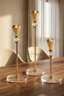 Three-piece gold candle holder set styled for a sophisticated dining table
